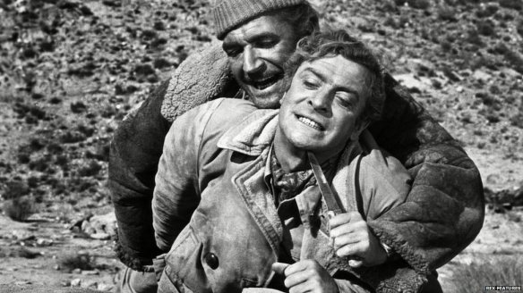 Nigel Davenport holds a knife to Michael Caine's throat in PLAY DIRTY (1969)
