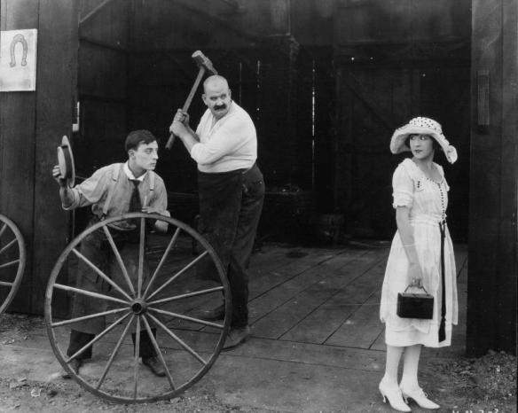 Buster Keaton, his irate boss Joe Roberts and his future fiancee Virginia Fox in The Blacksmith (1922)