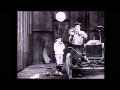 A kid with a balloon antagonizes Buster Keaton in The Blacksmith (1922)