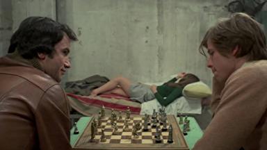 Simon Andreu (left), Inma de Santis (background) and John Moulder-Brown in Forbidden Love Game (1975)
