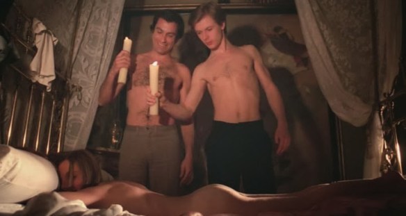 Simon Andreu (left) and John Moulder-Brown ogle Inma de Santis who appears to be sleeping...or is she? (from Forbidden Love Games, 1975)