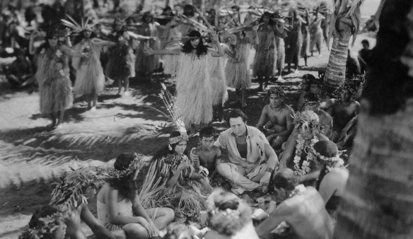 Monte Blue (center, beside native boy) in the wedding ceremony scene from White Shadows in the South Seas (1928)