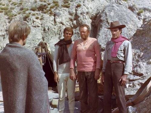Klaus Kinski (far left) aims his gun at his fellow gold hunters in The Ruthless Four (1968)