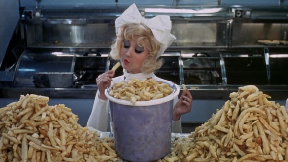 Adrienne Posta has a fondness for chips in Here We Go Round the Mulberry Bush (1967)