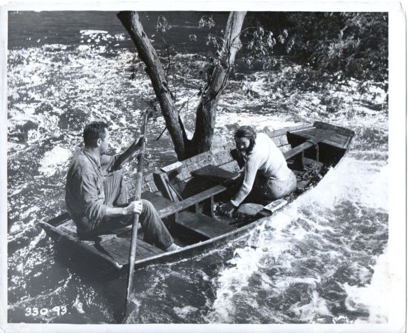 Howard Keel and Anne Heywood try to navigate to safety in Floods of Fear (1958)