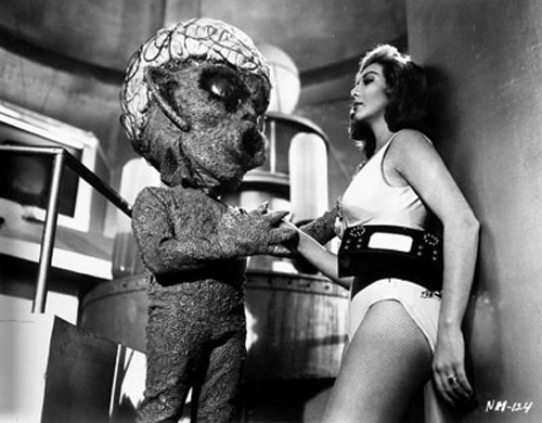 A Venusian woman (Lorena Velazquez, right) contemplates the breeding potential of an alien suitor in La Nave de los Monstruos (1960)
