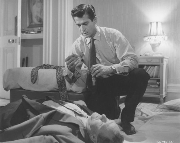George Nader and a lifeless Bernard Lee in a scene from Nowhere to Go (1958)