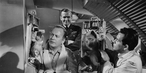 Curd Jurgens (far left) experiments with monkeys for his space exploration program in I Aim at the Stars (1960)