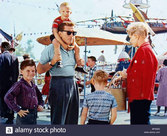Married architect Kirk Douglas with his kids meets housewife Kim Novak and her child in Strangers When We Meet (1960).