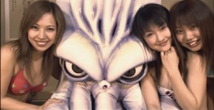 Female fans pose with Japan's latest sports hero in The Calamari Wrestler (2004).
