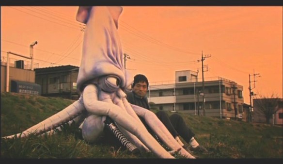 Calamari has a heart to heart talk with his pal under the polluted twilight sky.