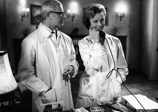 Two asylum doctors discuss their escaped patient (played by Klaus Kinski) in Der Rote Rausch (1962).