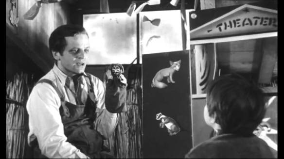 Martin (Klaus Kinski), an escaped mental patient, performs a puppet show for a lonely young girl in Der Rote Rausch (1962).